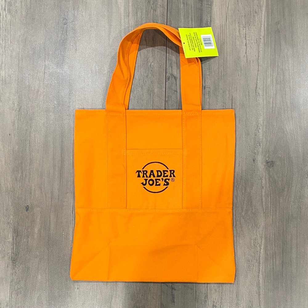 Trader Joe's alternated mini tote .  13”x 14”. Orange color .  Fits folders